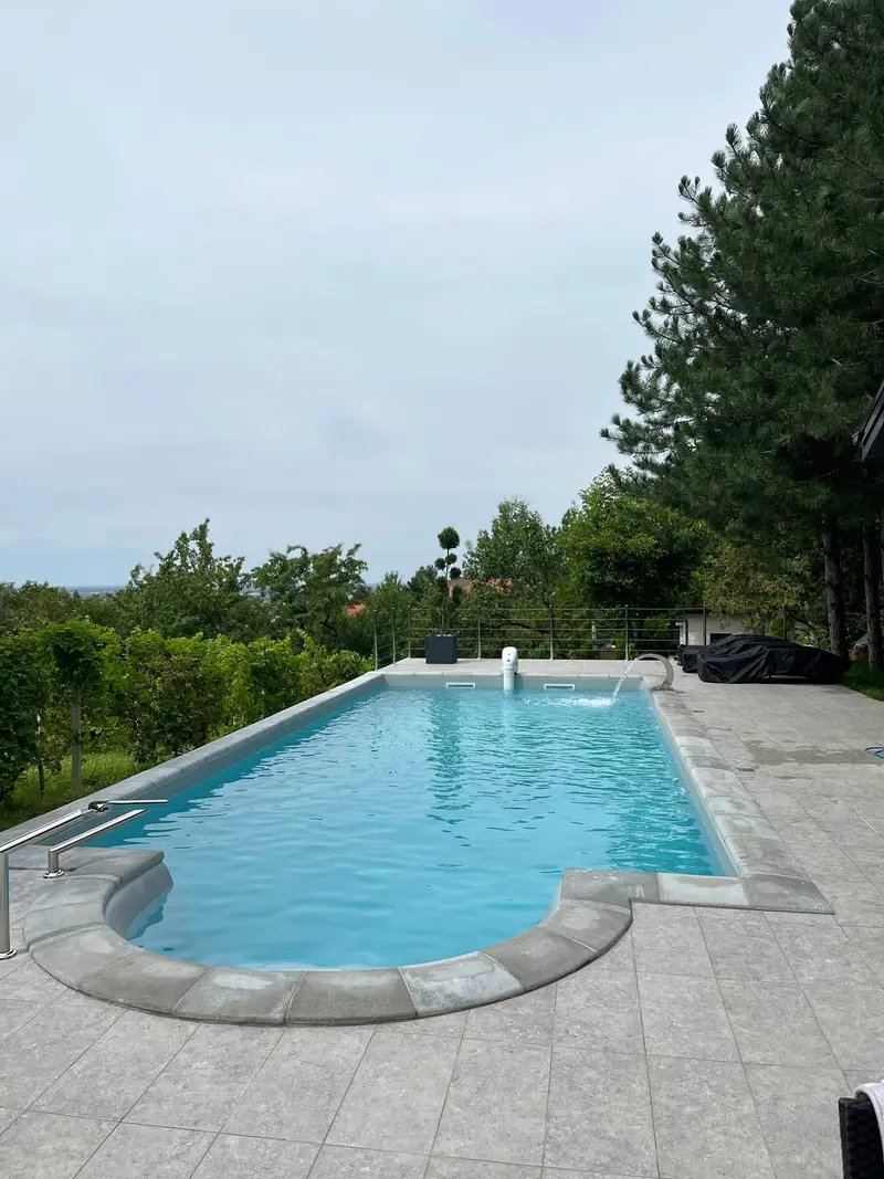 Rectangular in-ground pool with a stone deck