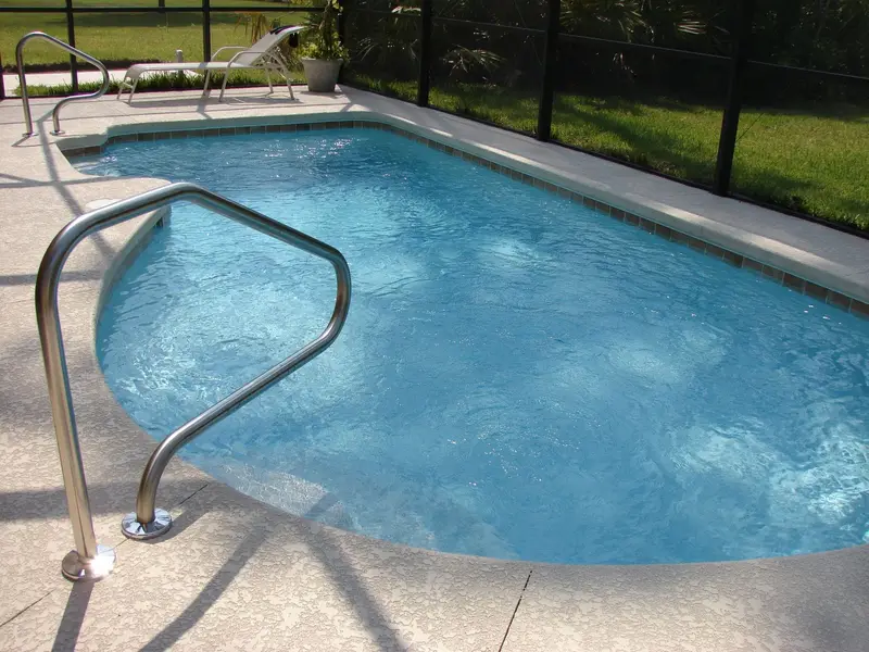 Residential pool with a stainless steel handrail